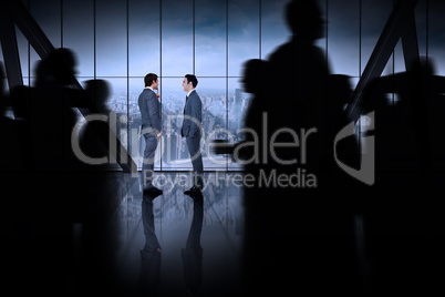 Composite image of silhouette of business people walking