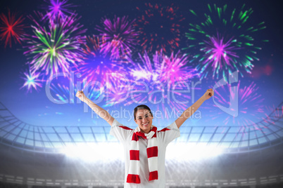 Composite image of excited asian football fan cheering