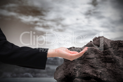 Composite image of businesswomans hand presenting