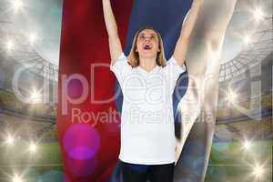 Composite image of cheering football fan in white holding russia