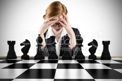 Composite image of redhead businesswoman with head in hands