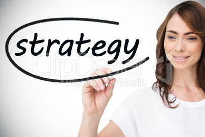 Businesswoman writing the word strategy