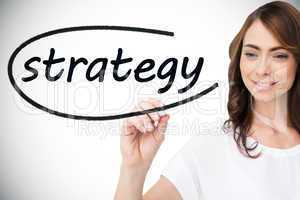 Businesswoman writing the word strategy