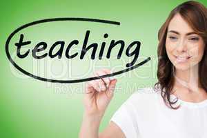 Businesswoman writing the word teaching