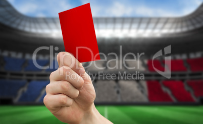 Composite image of hand holding up red card