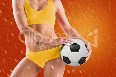 Composite image of fit girl in yellow bikini holding football