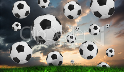 Composite image of black and white footballs