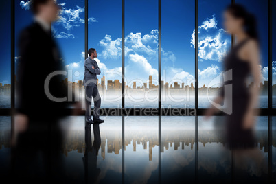 Composite image of business people walking in a blur