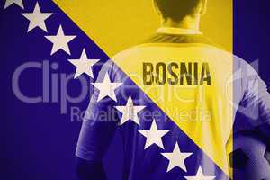 Composite image of bosnia football player holding ball