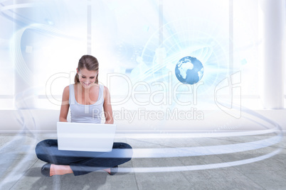 Composite image of cross legged woman using a laptop