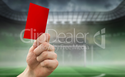 Composite image of hand holding up red card