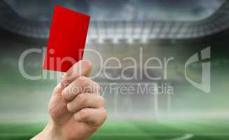 Composite image of hand holding up red card