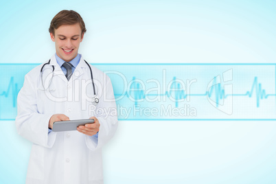 Composite image of young doctor using tablet pc