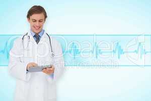 Composite image of young doctor using tablet pc