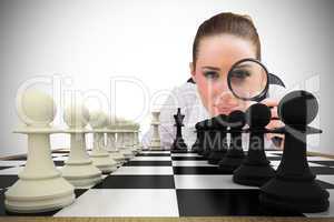 Composite image of thinking businesswoman with magnifying glass