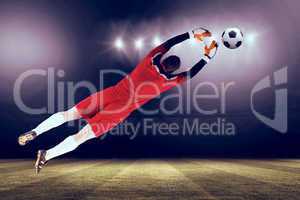 Composite image of goalkeeper in red jumping up