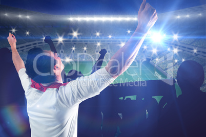 Composite image of excited football fan cheering