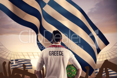 Composite image of greece football player holding ball