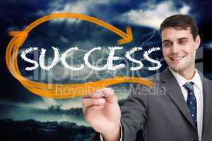 Businessman writing the word success