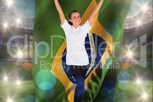 Composite image of excited football fan in white cheering holdin