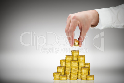 Composite image of businessman holding coins