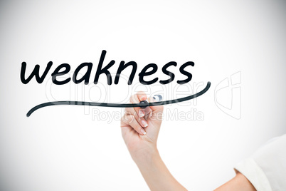 Businesswoman writing the word weaknesses