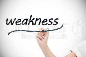 Businesswoman writing the word weaknesses