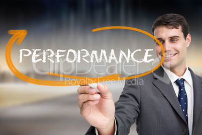 Businessman writing the word performance