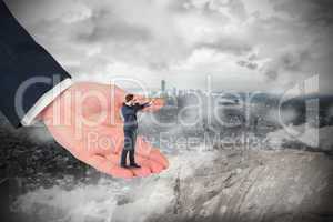 Composite image of businessman looking through telescope in larg