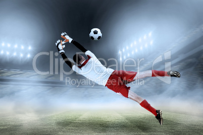 Composite image of fit goal keeper jumping up