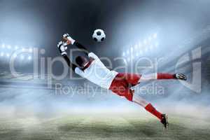 Composite image of fit goal keeper jumping up