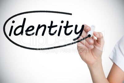 Businesswoman writing the word identity