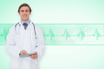 Composite image of young doctor using tablet pc