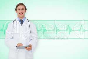 Composite image of young doctor using tablet pc