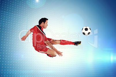 Composite image of football player in red kicking