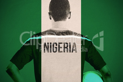 Composite image of nigeria football player holding ball
