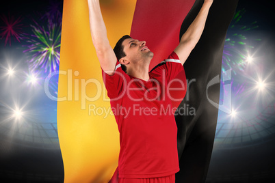 Composite image of excited football player cheering