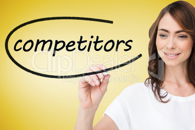 Businesswoman writing the word competitors