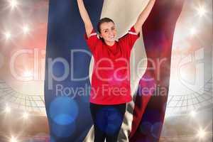 Composite image of excited football fan in red cheering holding