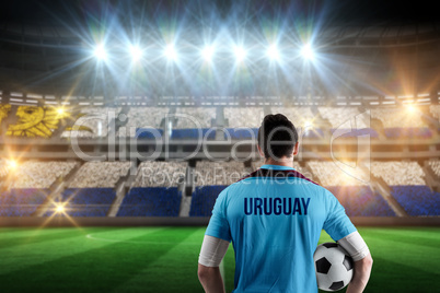 Composite image of uruguay football player holding ball