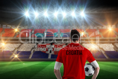 Composite image of croatia football player holding ball