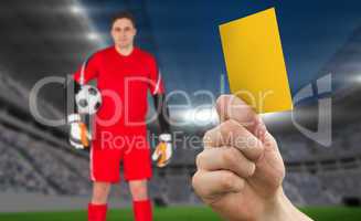 Composite image of hand holding up yellow card