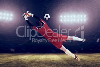 Composite image of goalkeeper in red jumping up