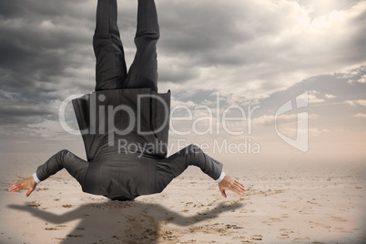 Composite image of businessman burying his head