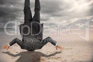 Composite image of businessman burying his head