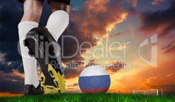 Composite image of football boot kicking russia ball