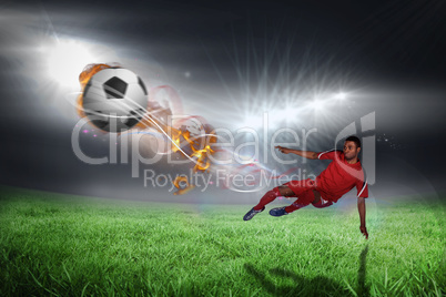 Composite image of football player in red kicking