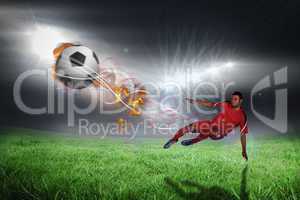 Composite image of football player in red kicking