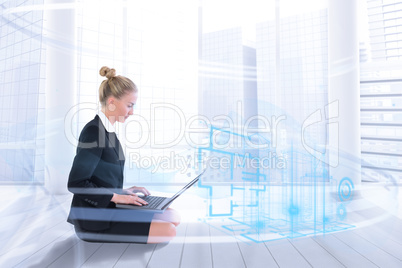 Composite image of businesswoman using laptop