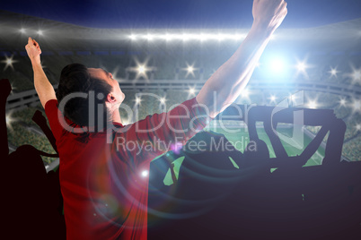 Composite image of cheering football fan in red jersey